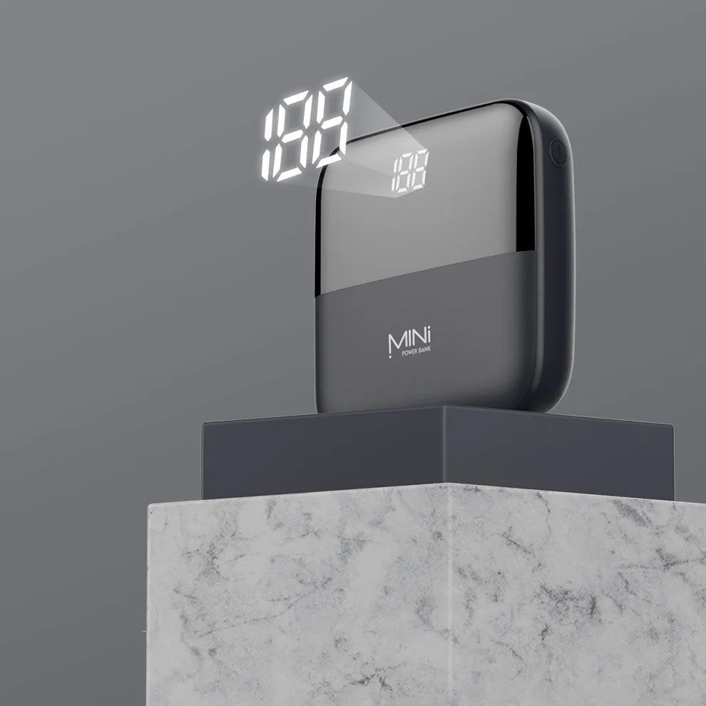 Black 10000mAh portable power bank with digital display showing battery percentage and dual USB ports.