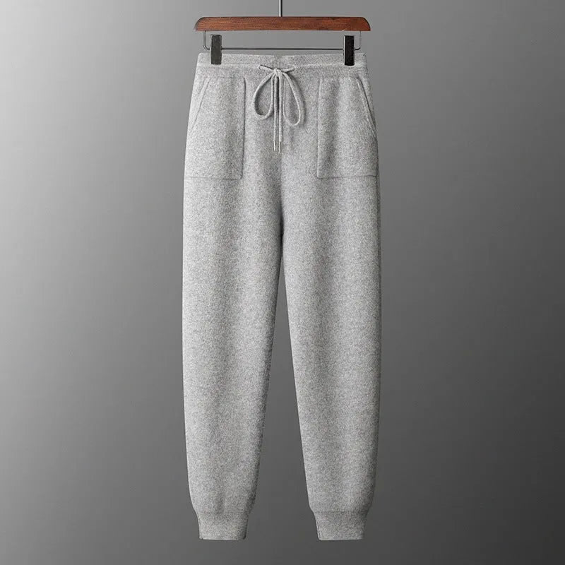 Men's light grey hooded cashmere sweatshirt and matching trousers laid flat as a complete casual set.