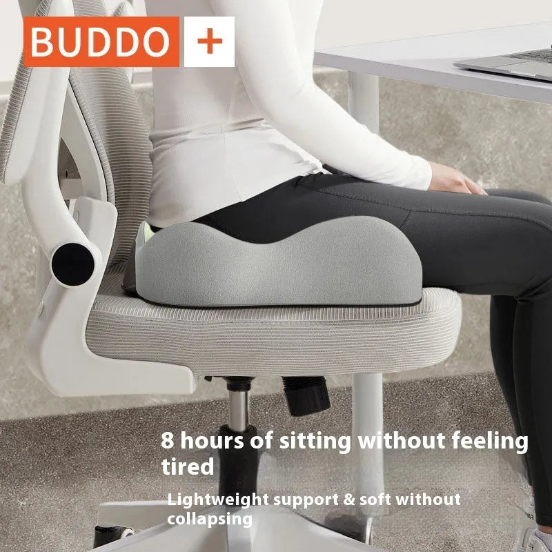 A solid colour memory foam seat cushion for lumbar support, shown in a grey colour option on an office chair.