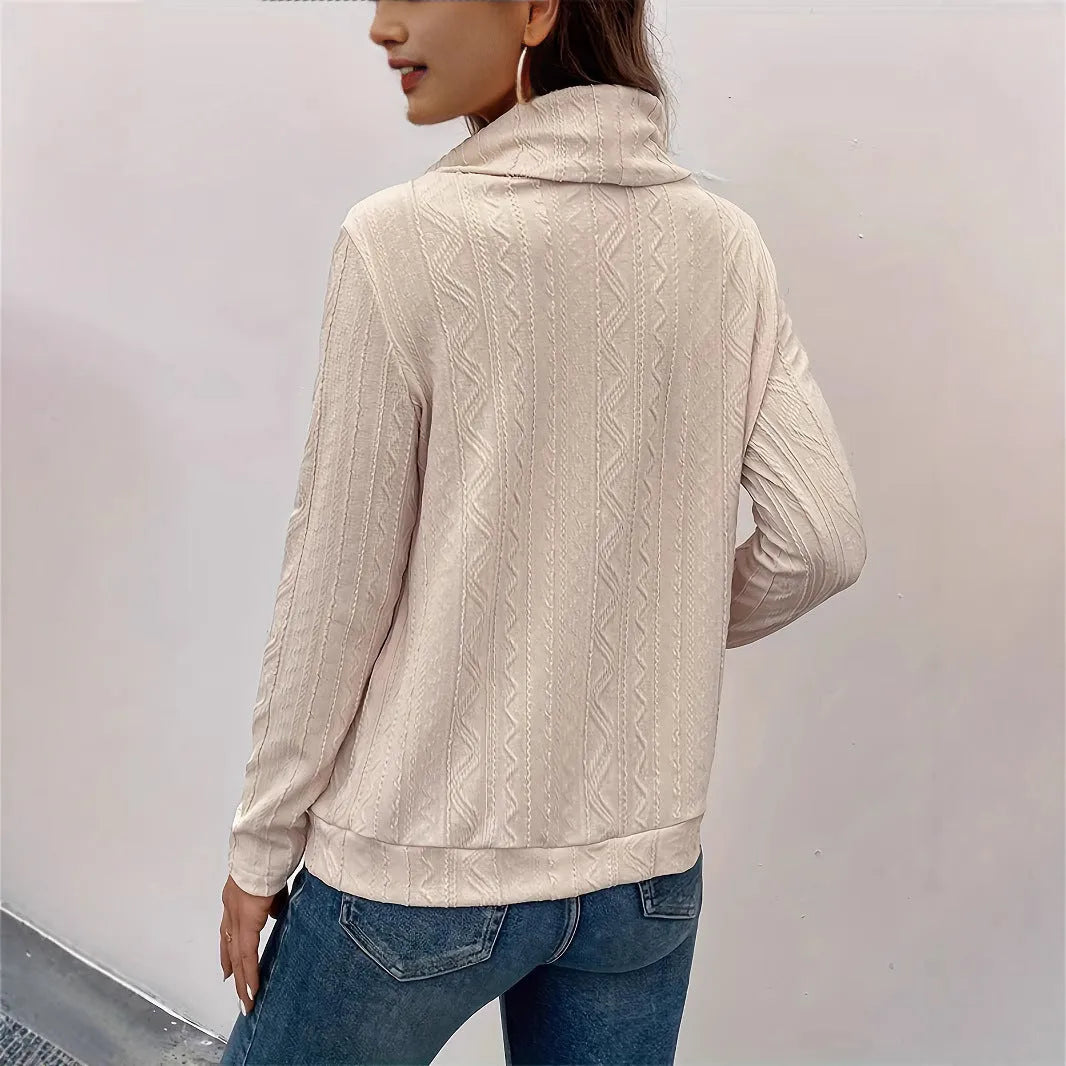 Apricot coloured long sleeve hooded pullover sweater on a hanger