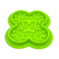 Silicone pet slow feeder licking pad in green colour on a wooden floor