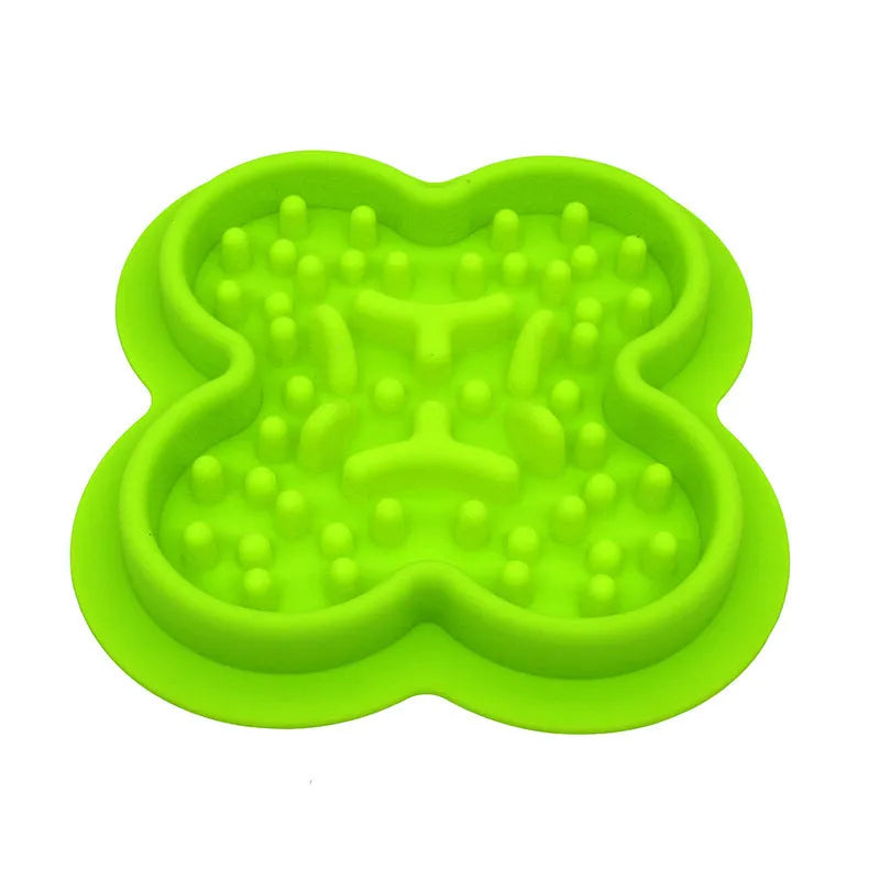 Silicone pet slow feeder licking pad in green colour on a wooden floor