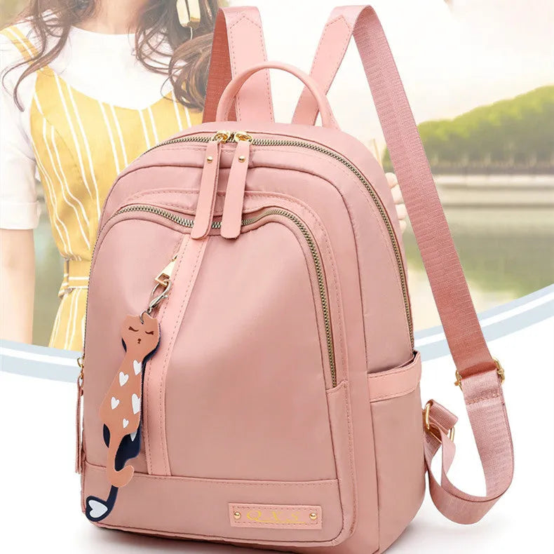 Women's nylon casual backpack in black with double shoulder straps and front pocket