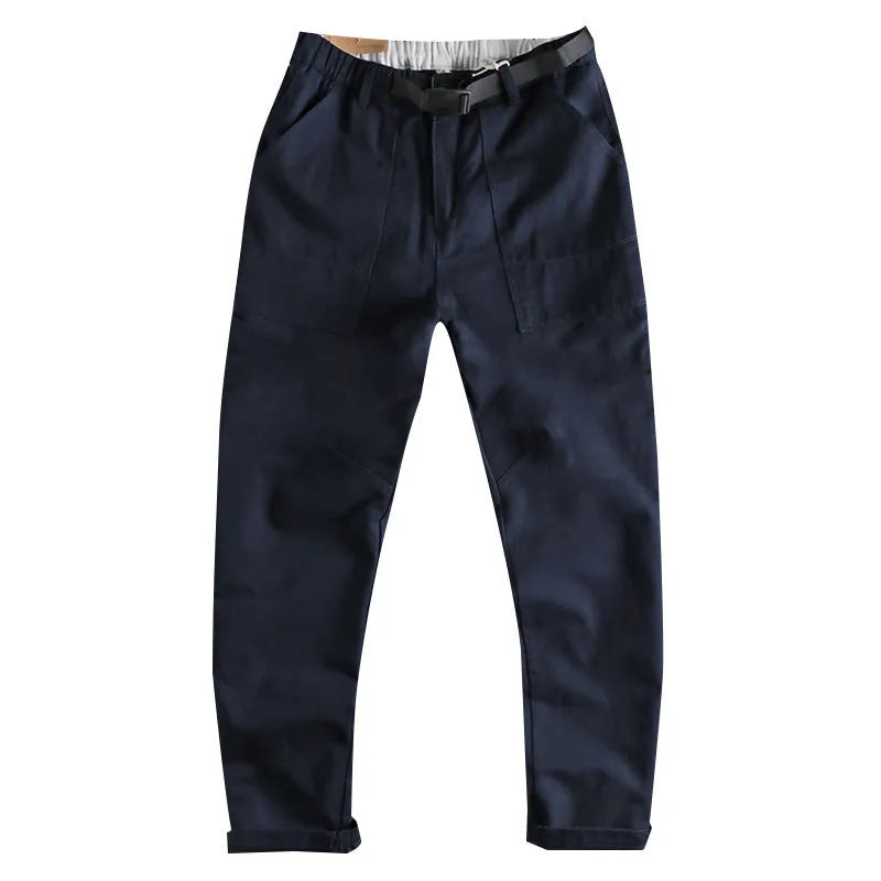 Men's khaki and dark blue cotton work trousers with mid waist and zipper fly on a size chart