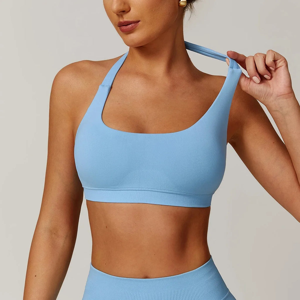 Women's black halter neck sports bra with medium support and built-in chest pads.