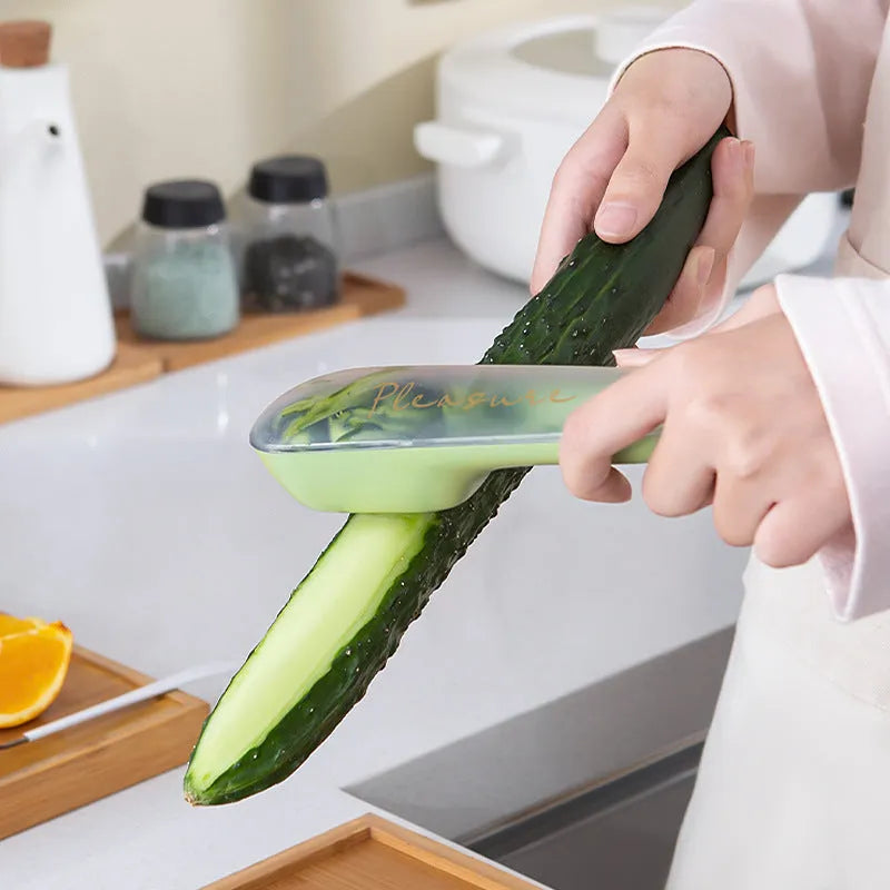Dark green stainless steel vegetable peeler with integrated storage box and non-slip handle for kitchen use
