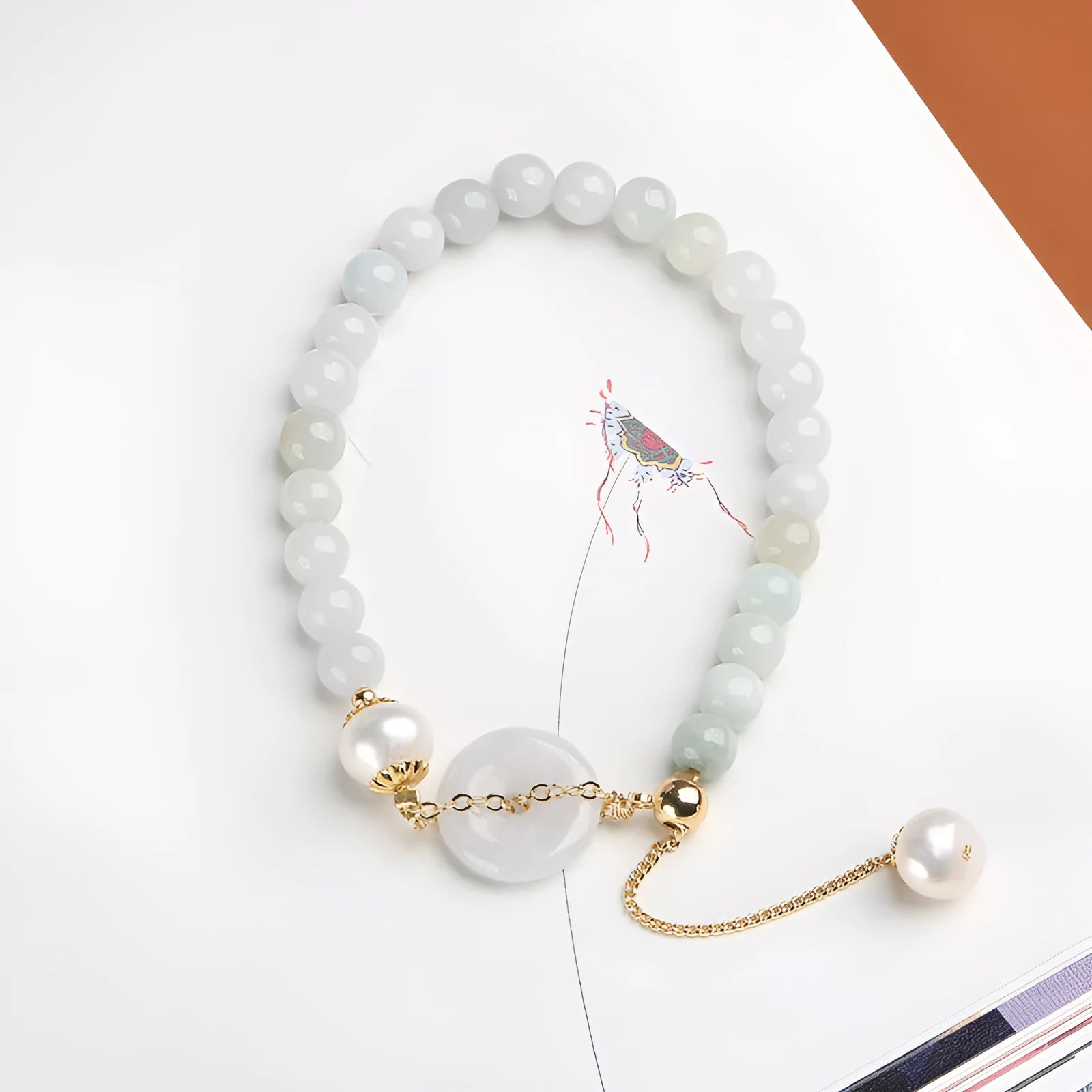 Natural emerald green jade and pearl bracelet with geometric peace buckle closure