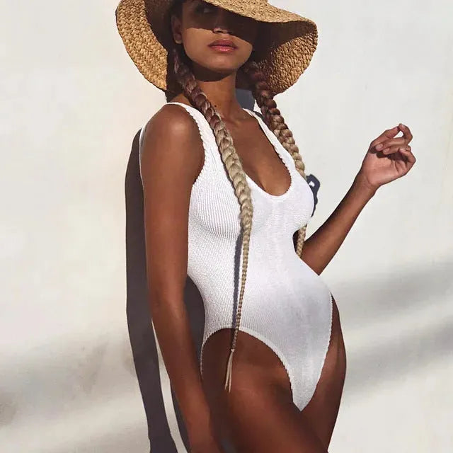 Women's solid colour backless one-piece swimsuit in seersucker fabric shown in multiple colour options.