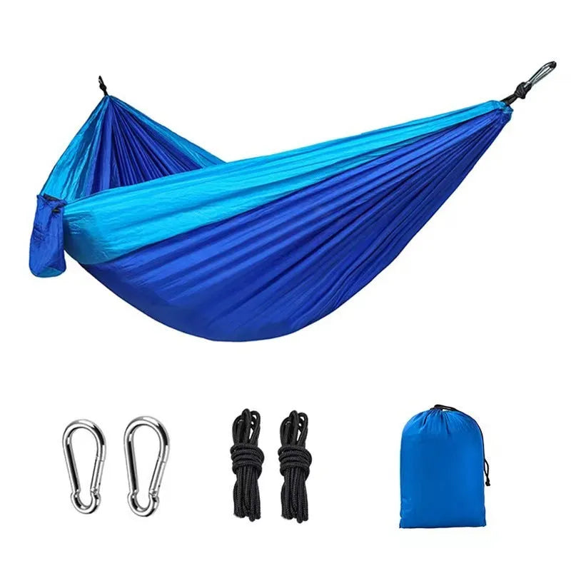 Blue nylon parachute cloth outdoor hammock hanging between trees
