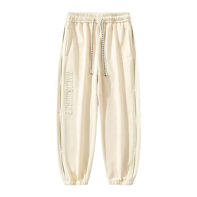 Men's grey green cotton casual trousers with white collage stitching detail and an elasticated ankle band.