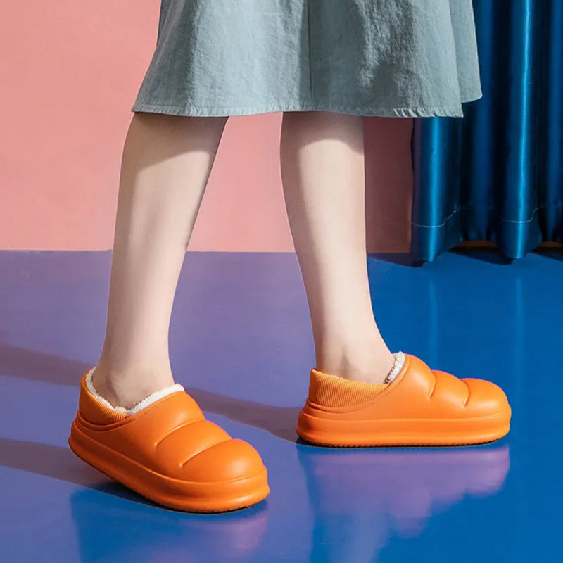 Waterproof EVA couple slippers in various colours showing hollow design and flat non-slip sole.