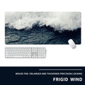Oversized black gaming mouse pad with printed design and integrated raised wrist rest on a desk.