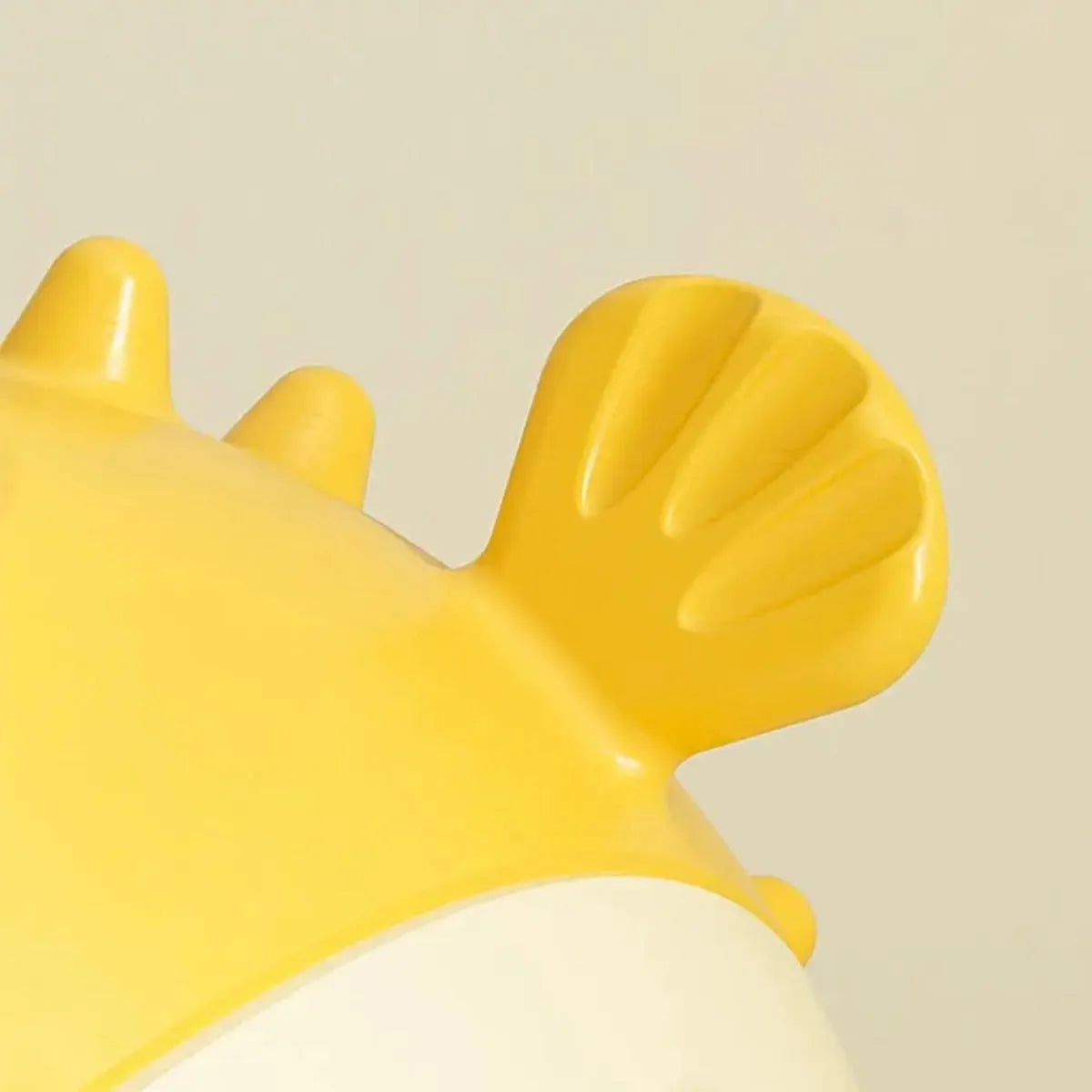 Yellow fish shaped vinyl dog chew toy with textured surface for teeth cleaning