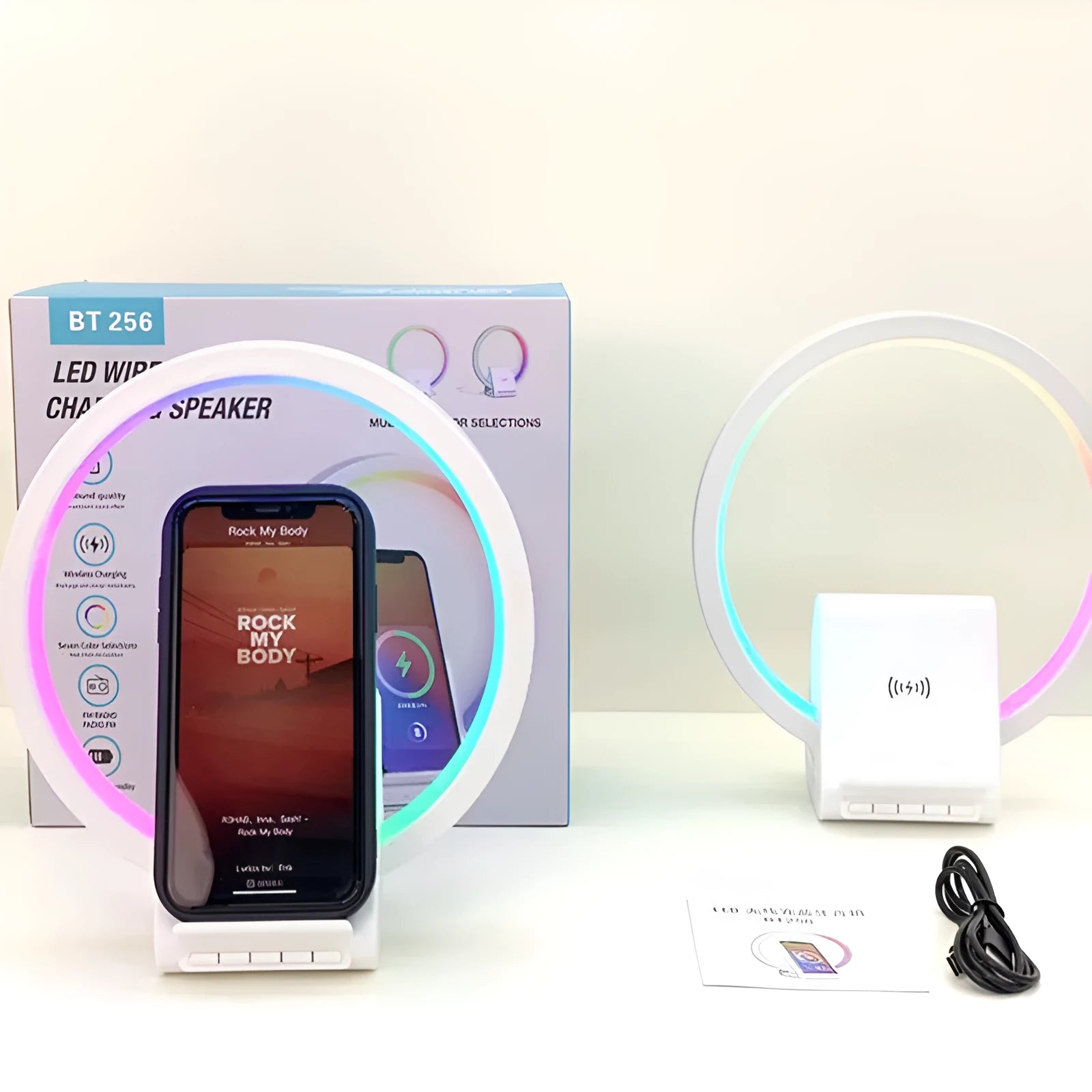 White rectangular smart device combining a wireless charging pad, Bluetooth speaker, and ambient light panel.