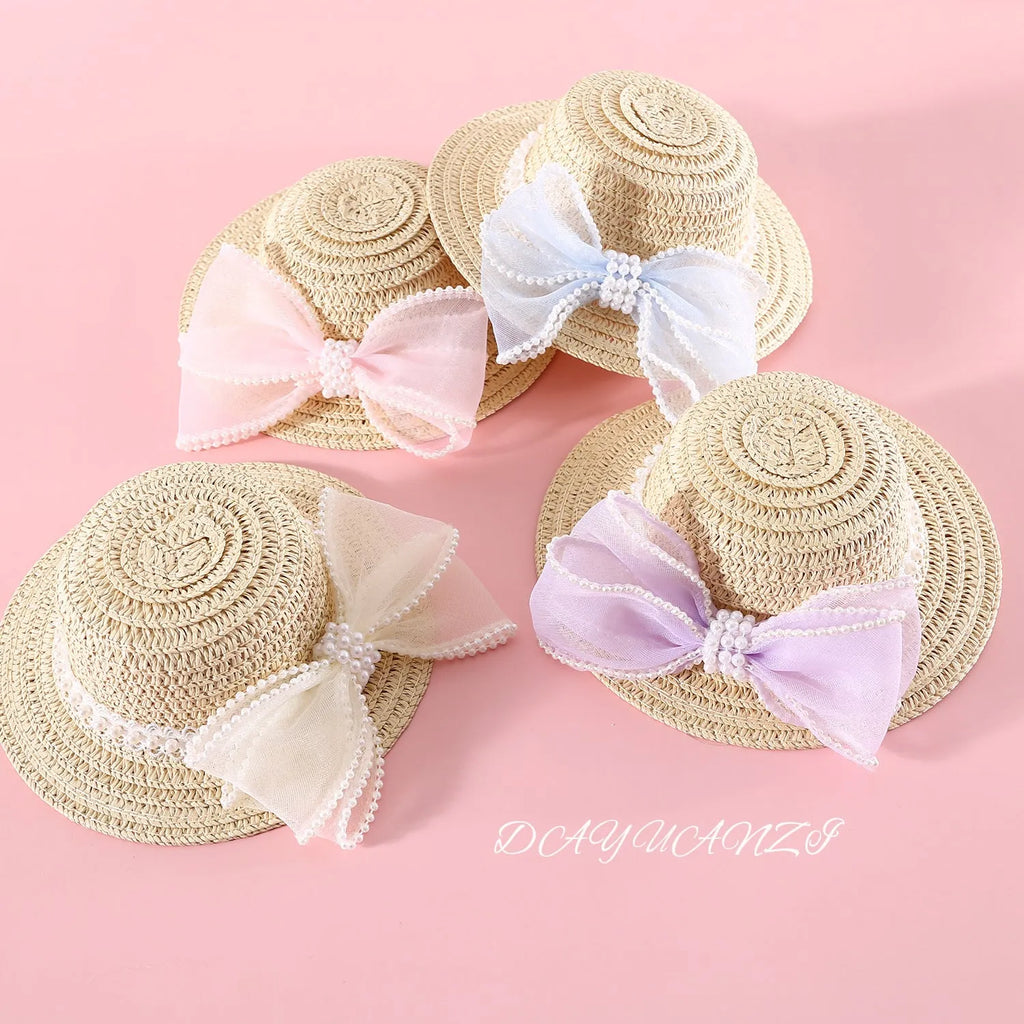 Woven Lafite leaves straw hat with pearl bow on a cat, showing pink pearl colour option in S 13cm size.