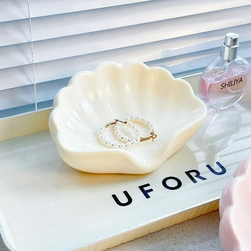 White and pink plastic shell-shaped soap dish for bathroom use