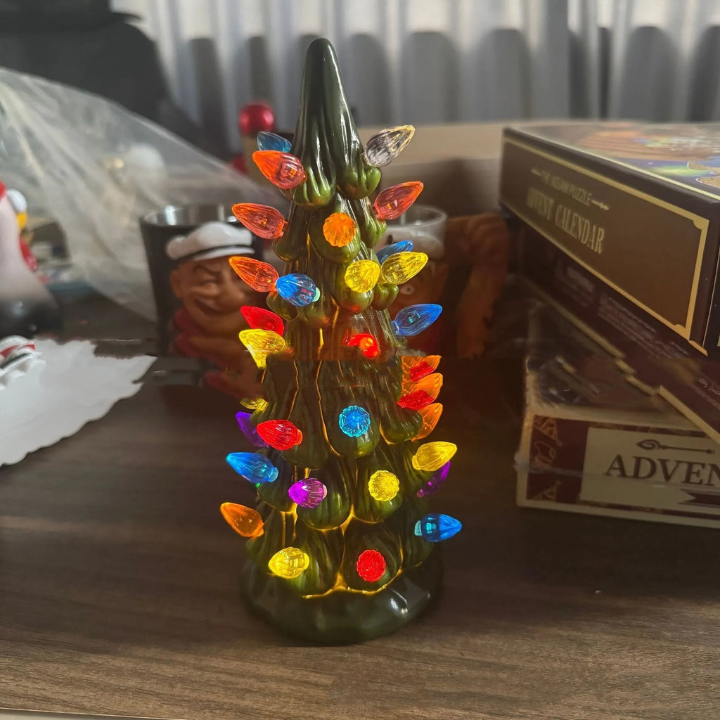 A European-style resin Christmas tree ornament with lights, shown in colour light and warm light variants.
