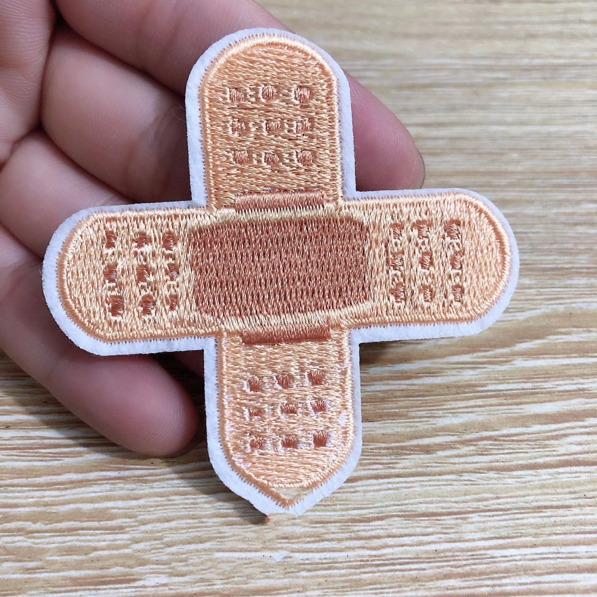 Set of 10 embroidered fabric patch badges with textured thread designs for clothing customisation.