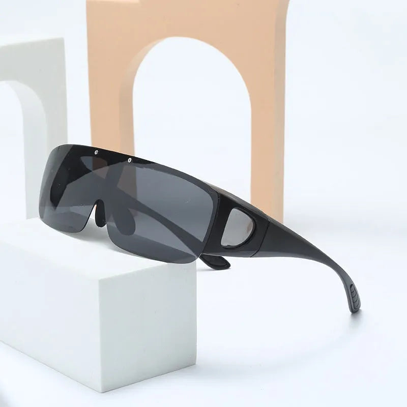 A pair of polarised sunglasses for myopia with one-piece lenses, shown in a colour option like black or green.