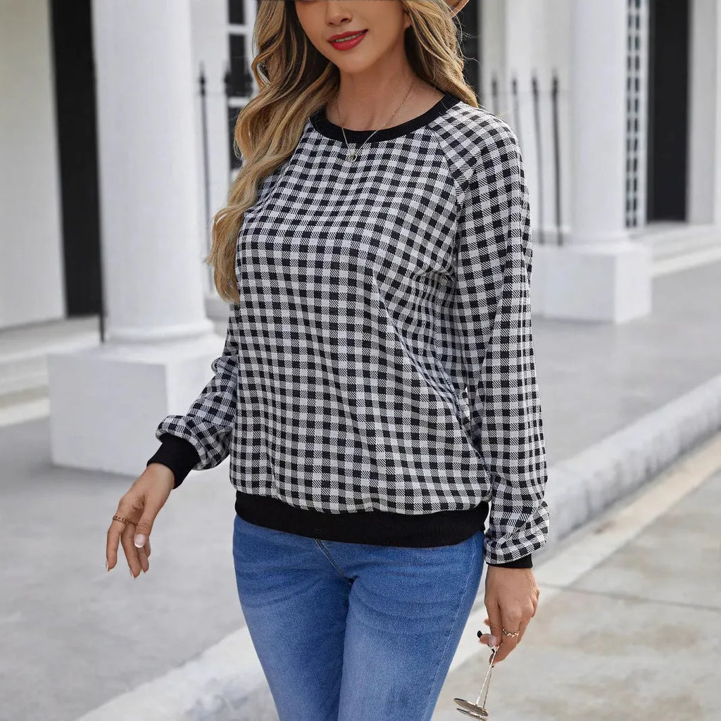 Black Japanese plaid pattern long sleeve pullover sweater on a hanger.