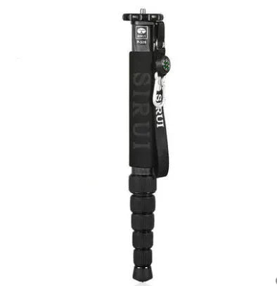 Black carbon fibre telescopic camera monopod fully extended next to a DSLR camera.