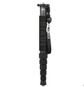 Black carbon fibre telescopic camera monopod fully extended next to a DSLR camera.