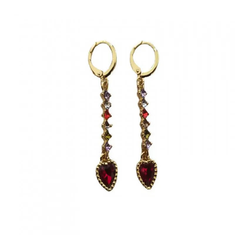 A pair of women's heart-shaped drop earrings with a gold electroplated finish.