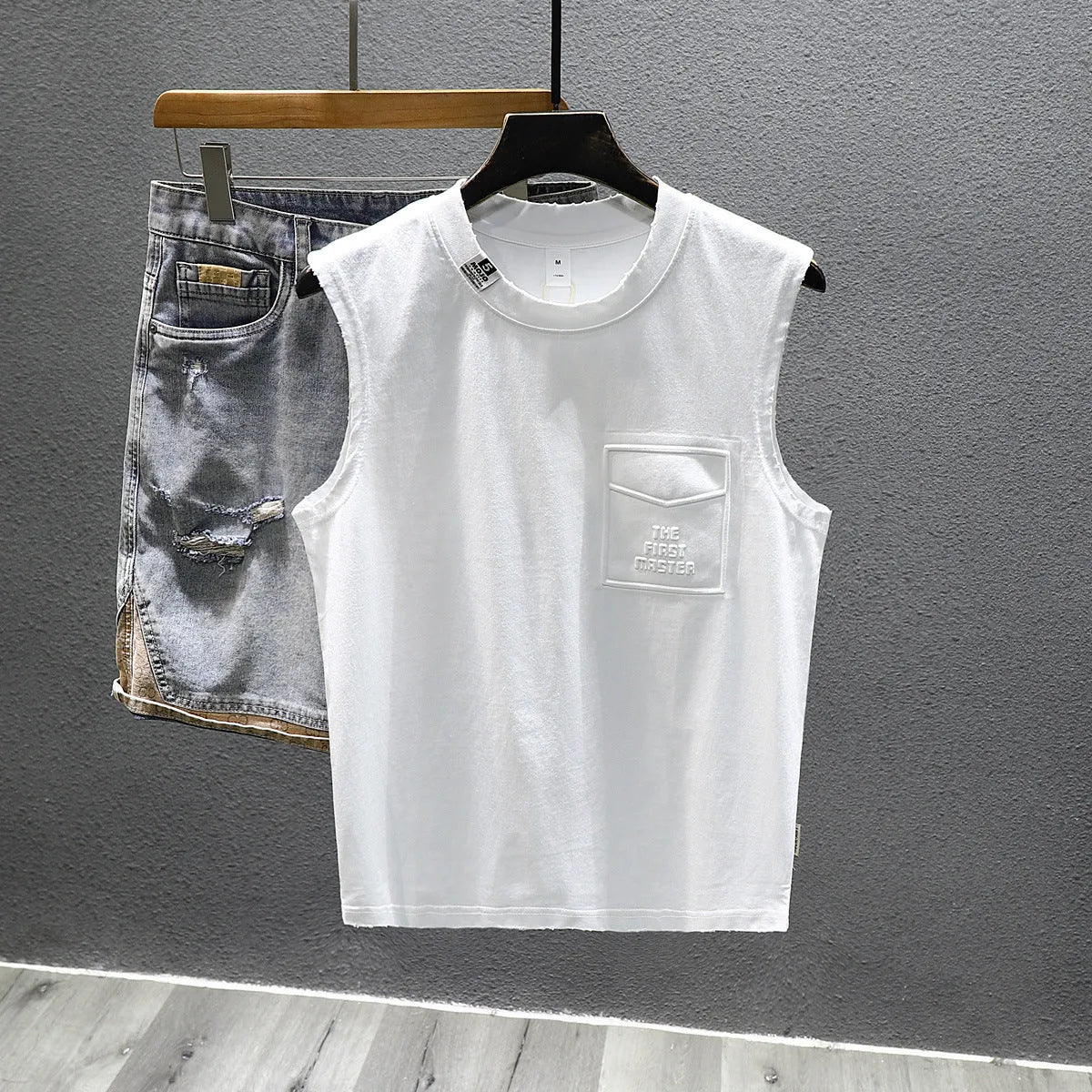 Solid colour loose cotton sleeveless t-shirt on a hanger in white or black