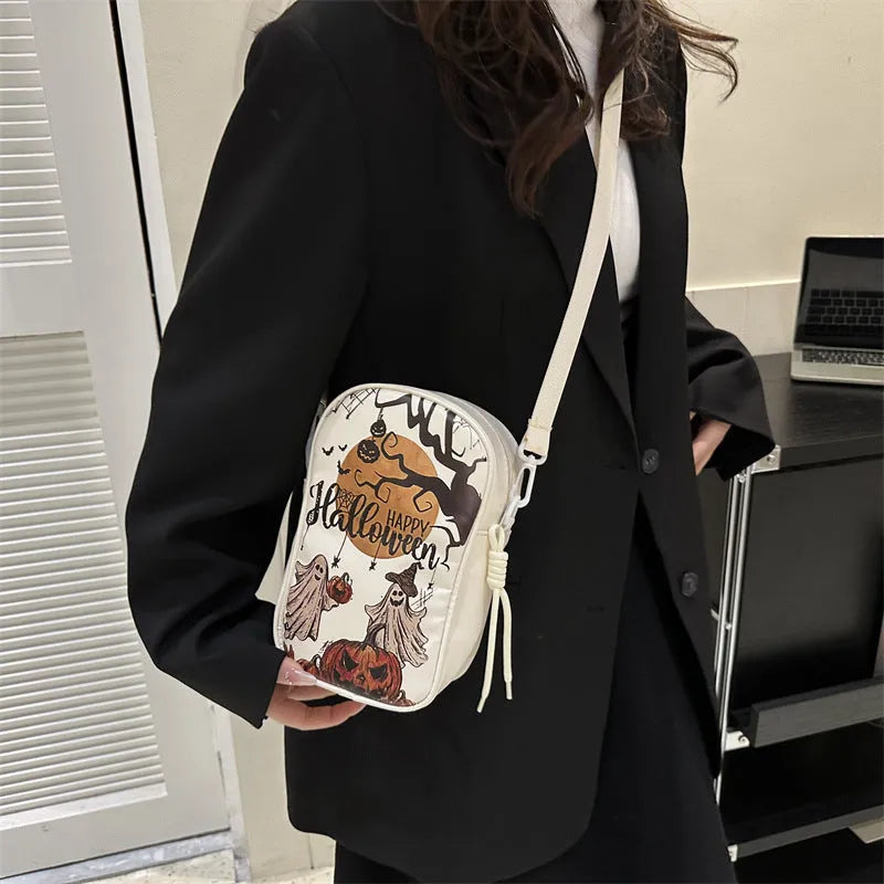 Halloween graffiti print crossbody bag with pumpkin ghost bat designs in black colour