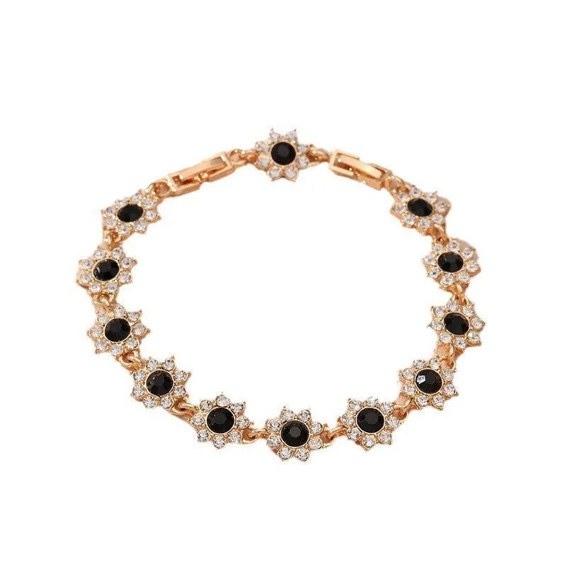 Gold and silver tone zinc alloy flower bracelet with electroplated coloured gemstones including crystal and diamond accents.