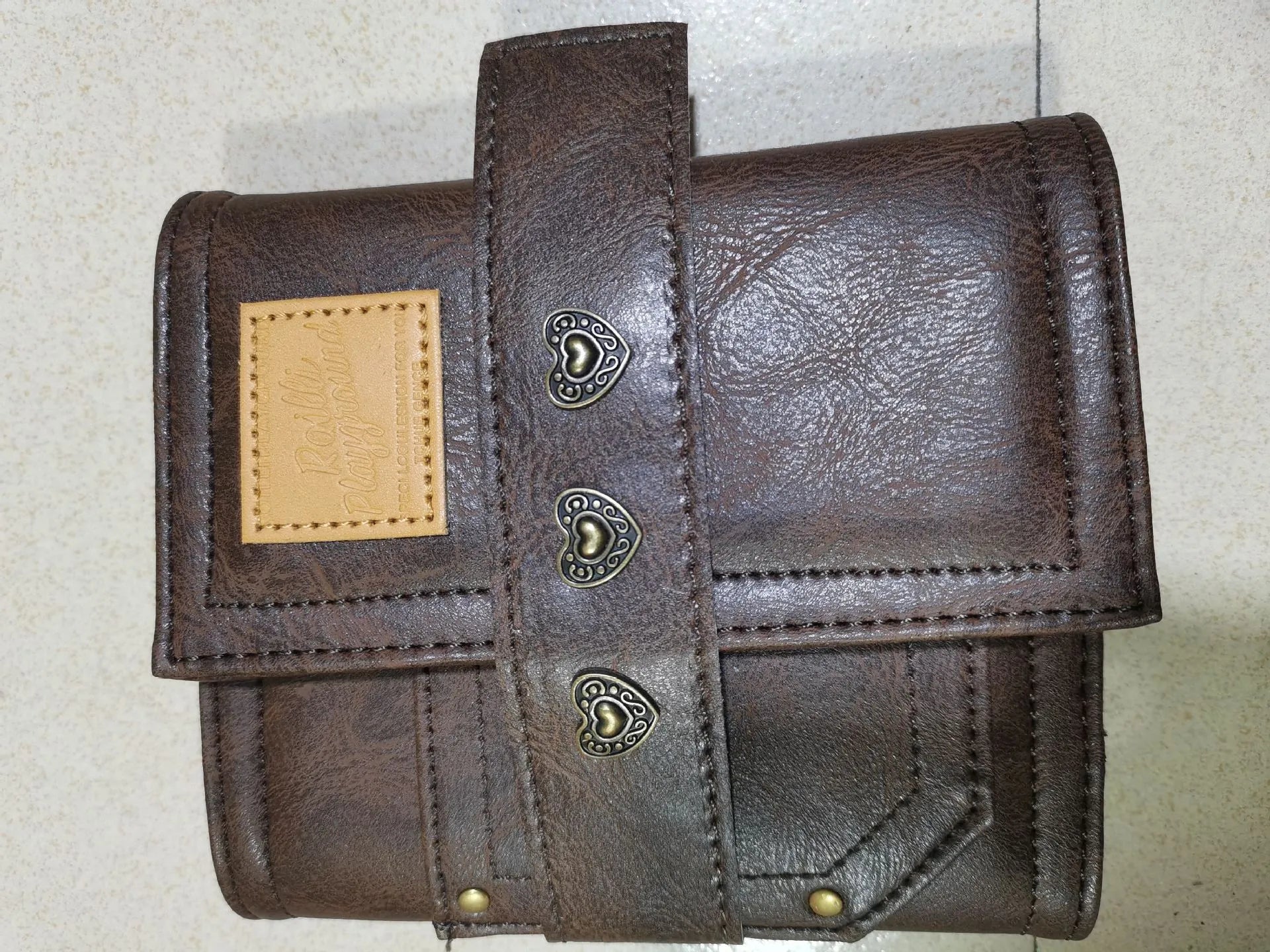A7 brown PU leather-style notebook with loose-leaf binder binding, open to show 40g raw wood pulp paper
