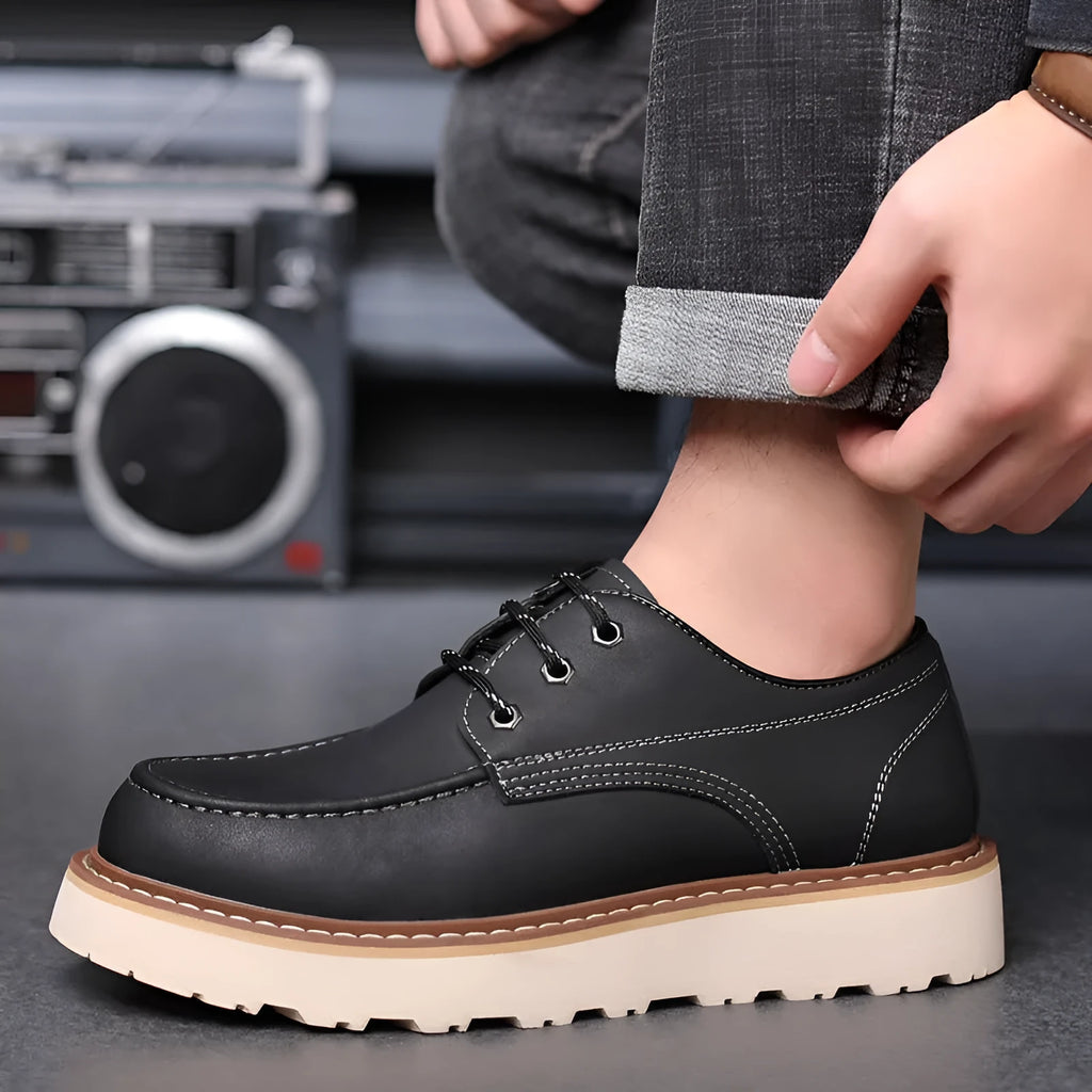 Men's black Martin boots with low-top retro design showing rubber sole and round toe shape