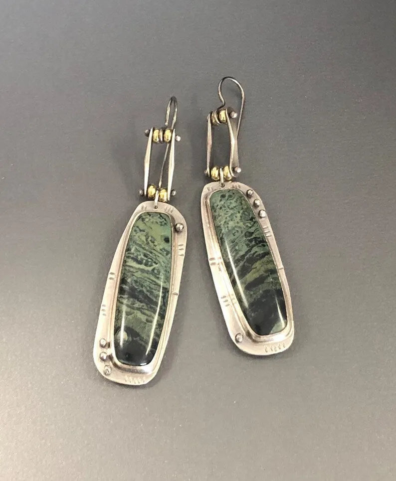 Pair of two-colour marble pattern geometric alloy earrings on simple background