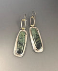 Pair of two-colour marble pattern geometric alloy earrings on simple background