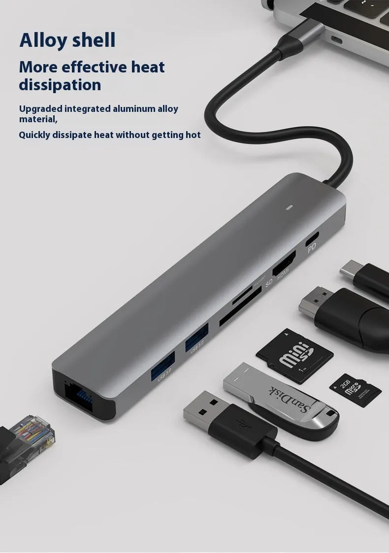 Silver USB C 7-in-1 hub dongle with SD card slot, micro SD slot, and USB C PD charging port.