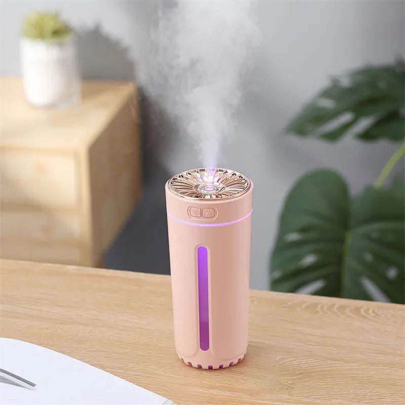 Black portable car humidifier with colourful LED lights on car cup holder showing mist output