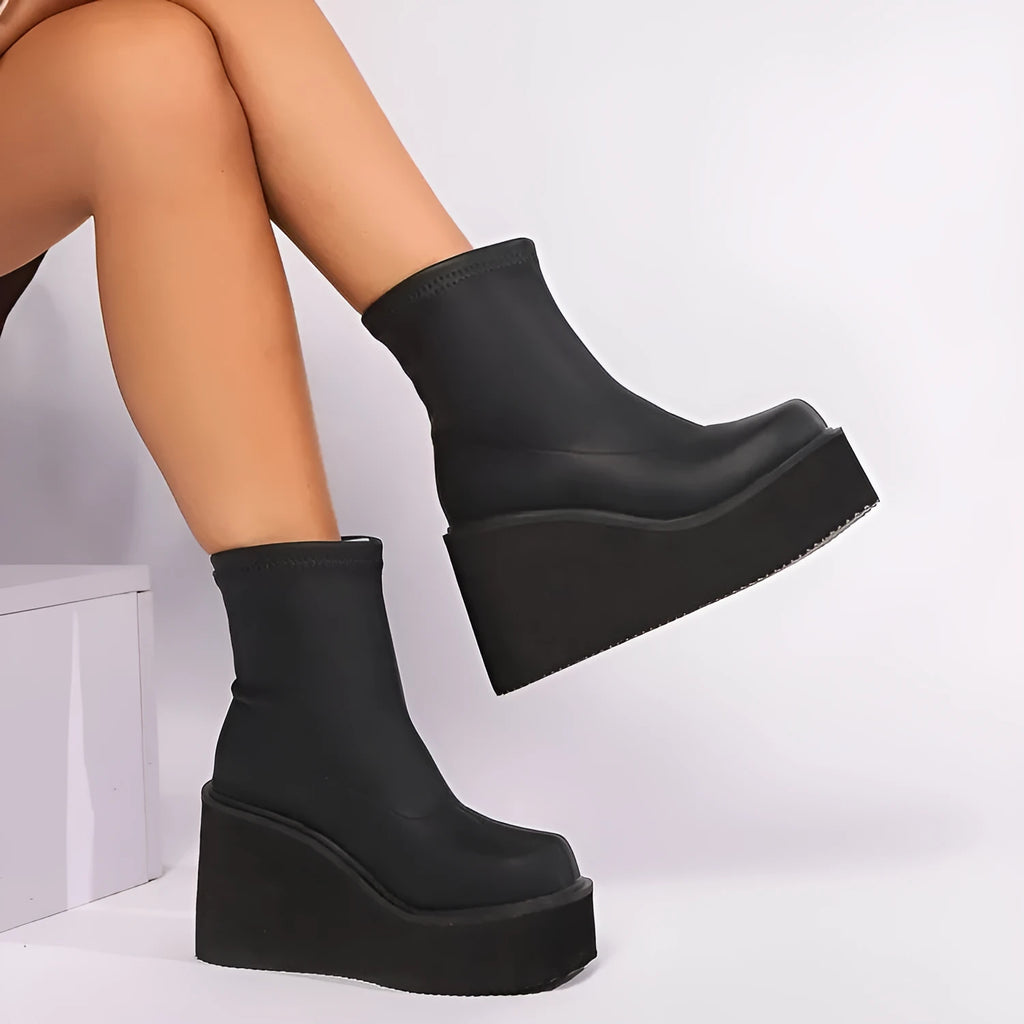 Plus size women's black wedge heel boots with a waterproof platform on a white background.