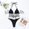 Black women's backless bikini set with long straps and metal ring details.