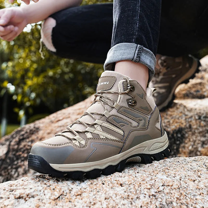 Men's black flannel high-top hiking sneakers with rubber sole and lace-up front on a rocky path.