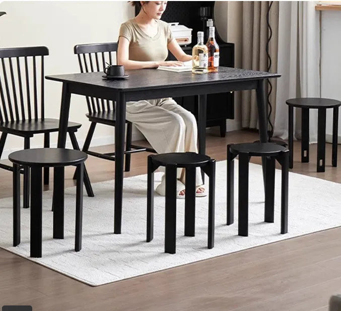 Stackable round iron dining stool in a modern design, shown in a choice of colours.