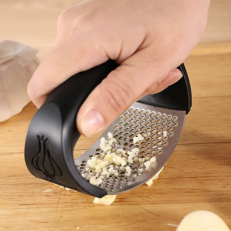 304 stainless steel garlic press with PP handle in 11cm size on kitchen counter