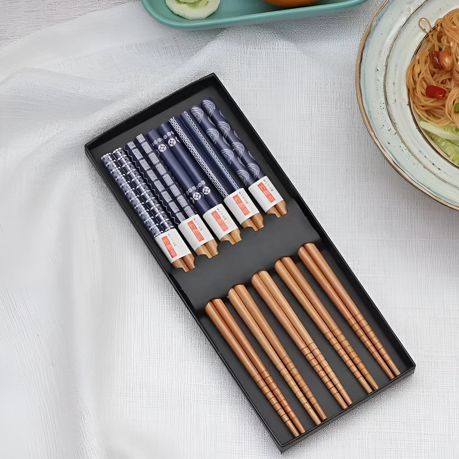 Five pairs of Japanese-style patterned bamboo chopsticks in lucky cat or elegant blue designs with cartoon patterns
