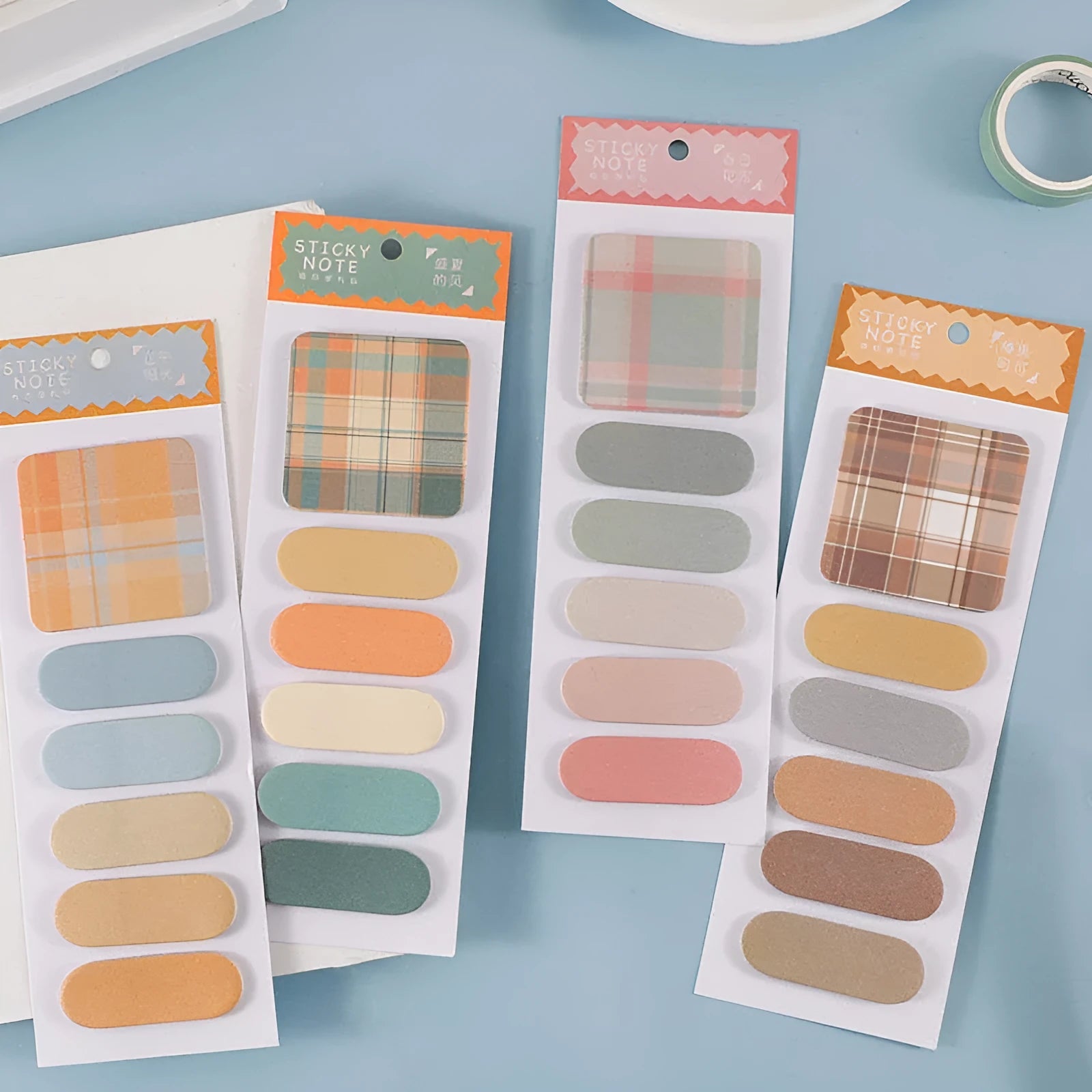 Colourful plaid design memo pad sticky notes in eight colour options showing Spring Garden and Twilight Coast covers