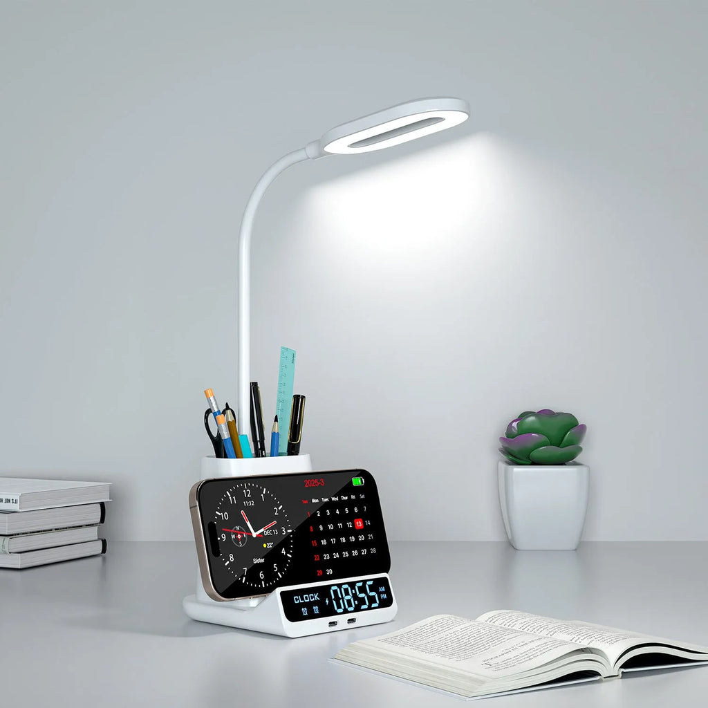Modern black and white desk lamp with wireless charging pad, pen holder, and storage compartment.