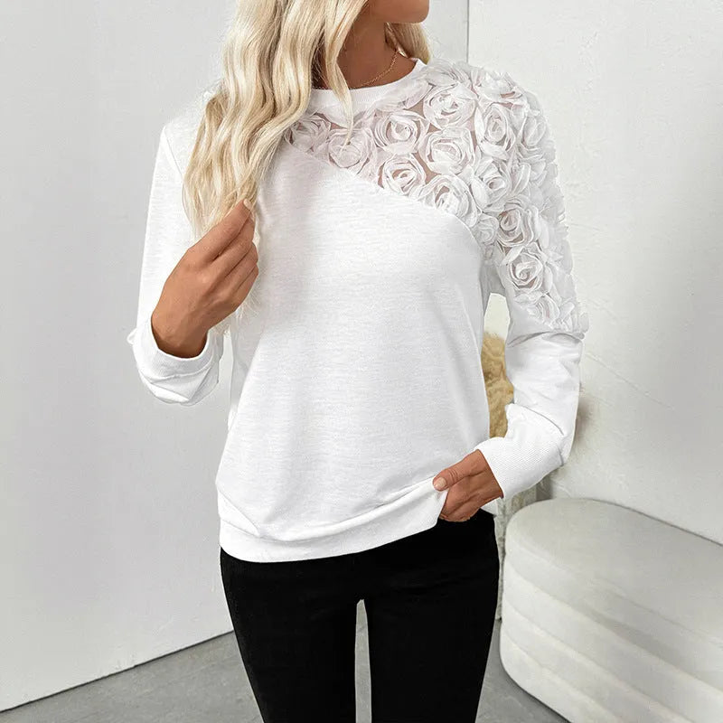 White long sleeve pullover top with a floral pattern, shown in a loose fit.