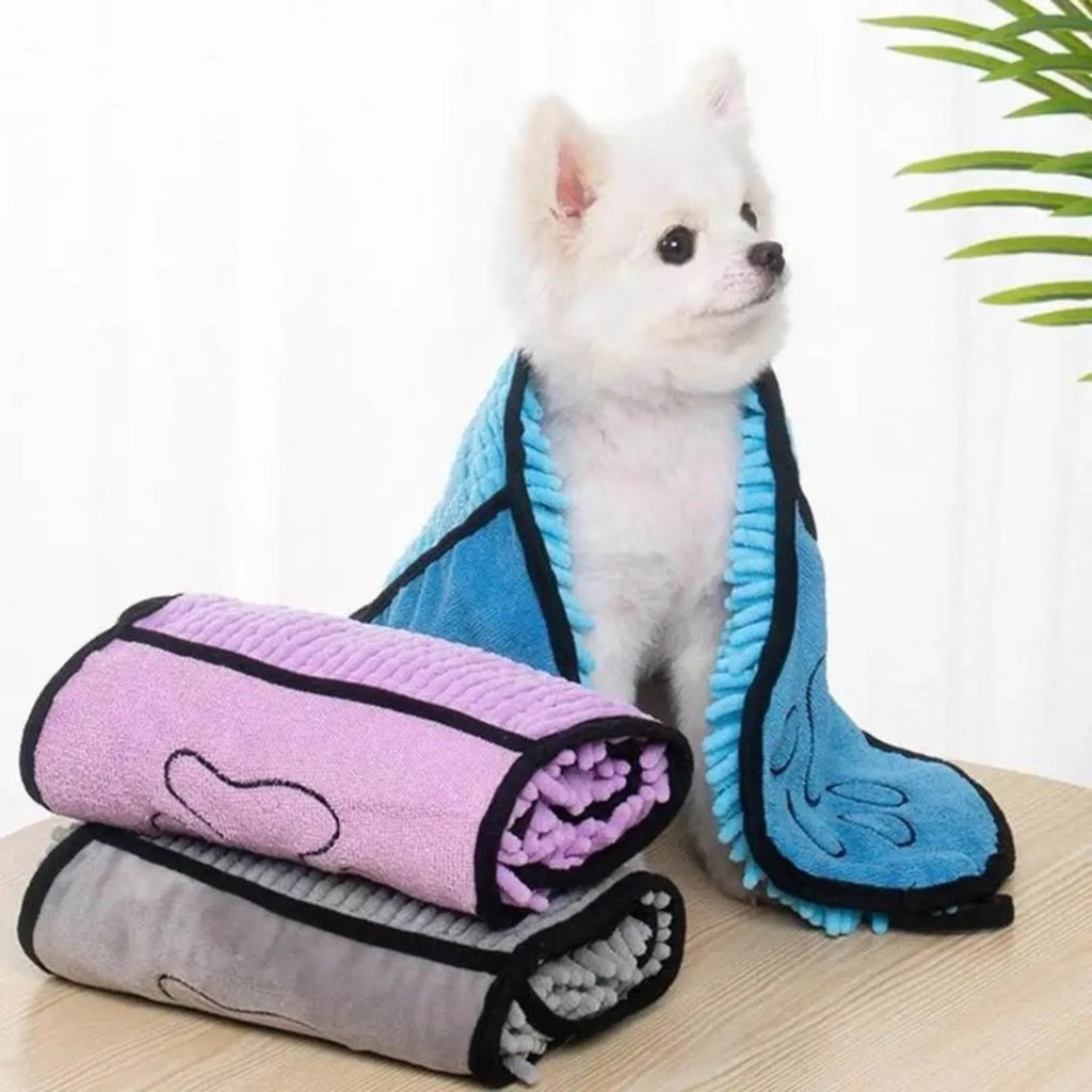 Blue pet bath robe towel wrapped around a small dog, showing its size and absorbent fabric.