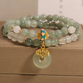 Women's double-layer aventurine jade bracelet in oil green with a safety buckle and rhinestone details.
