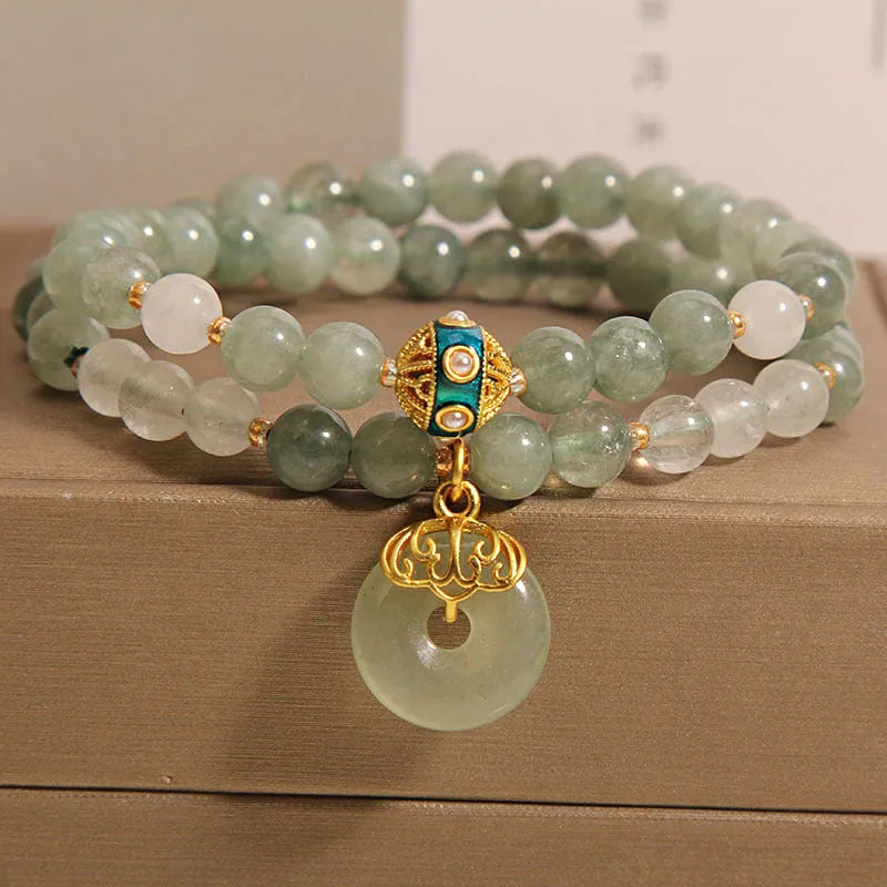 Women's double-layer aventurine jade bracelet in oil green with a safety buckle and rhinestone details.
