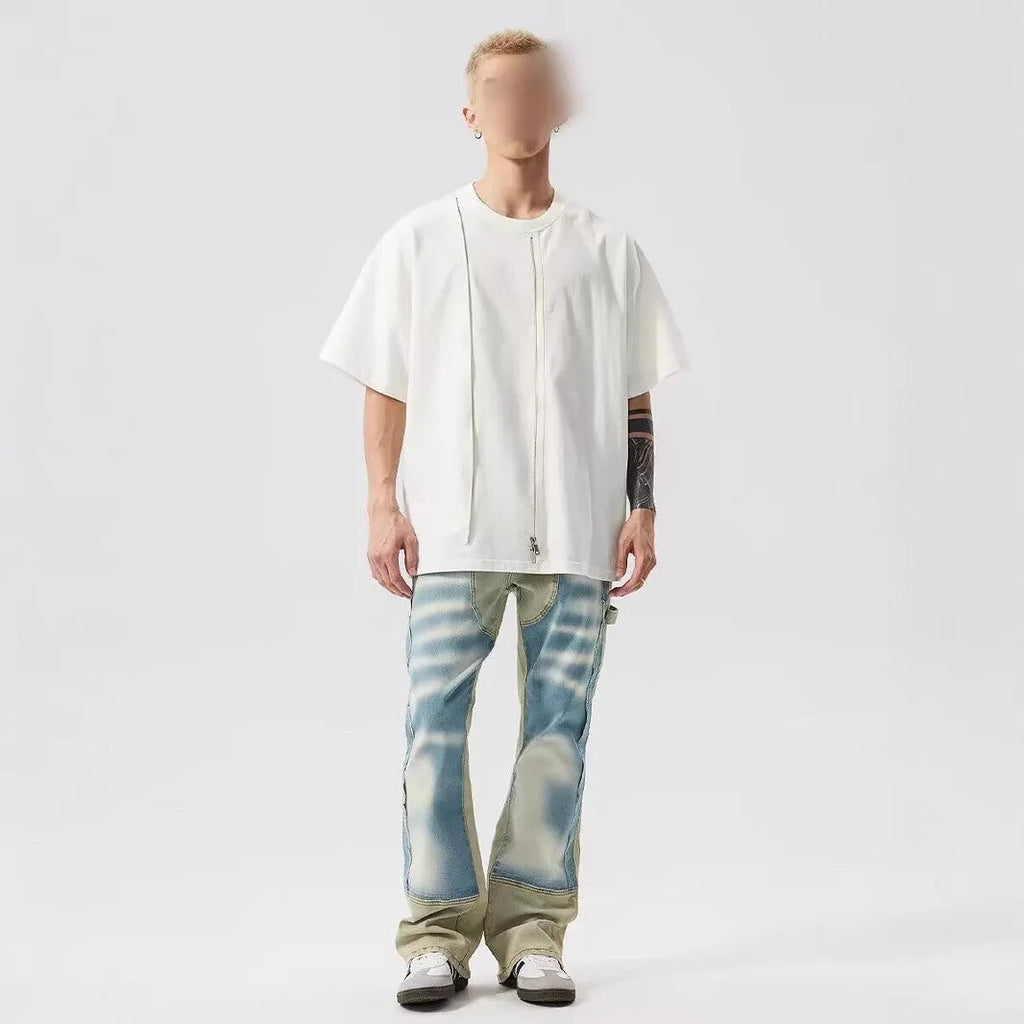 Men's yellow and blue patchwork jeans with a retro splash-ink damaged design on the legs.