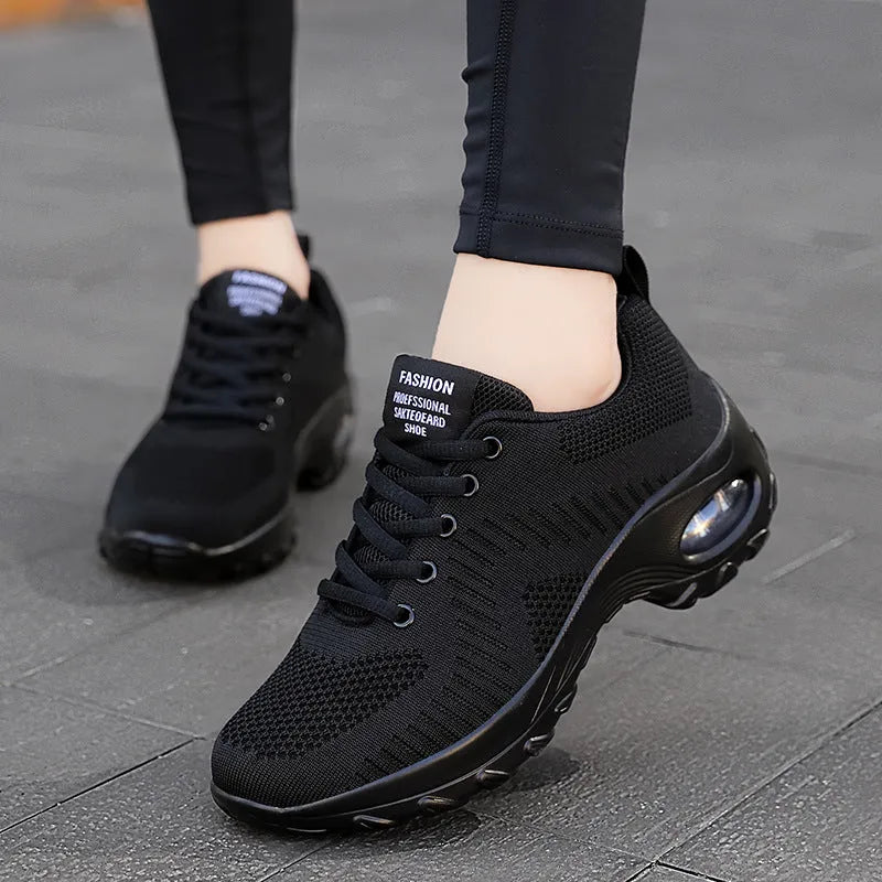 Women's red low-top lace-up mesh sneakers with round toe and a visible mid-height sole.